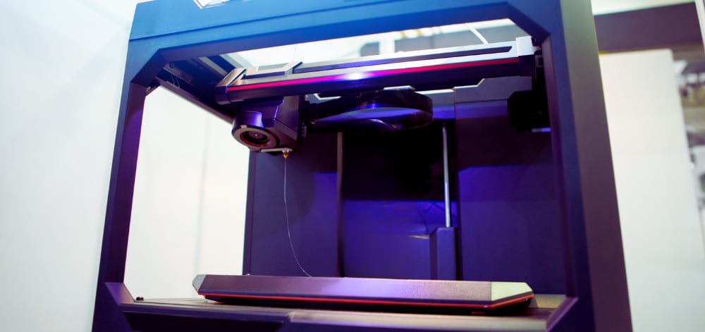 A 3D printer in a well lit room photo shot at an angle facing up